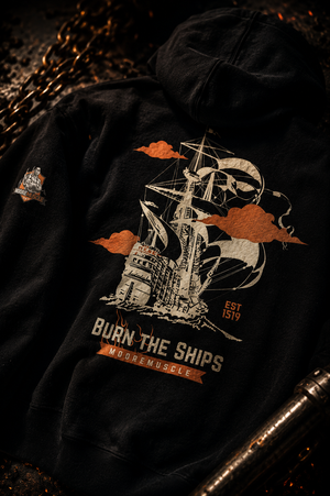 Close-up detail photo of the Burn The Ships back graphic printed on a black MooreMuscle heavyweight oversized hoodie.