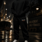 Burn The Ships heavyweight fleece sweatpants worn in an industrial harbor setting, featuring embroidered Burn The Ships EST. 1519 design and relaxed streetwear fit.