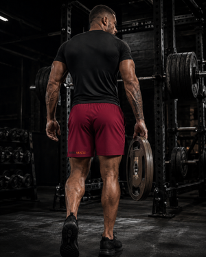 Female athlete wearing MooreMuscle Squat Collection workout shorts with wolf graphic in gym