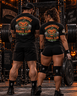 Man and woman both wearing the MMBC Halloween Tee 2026 unisex fit, Haunt the Platform design on the back