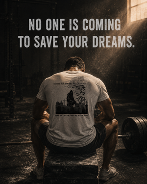 Exhausted athlete resting after training in the MooreMuscle Excuses Kill Dreams motivational t-shirt.