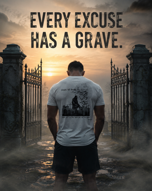Athlete wearing the MooreMuscle Excuses Kill Dreams tri-blend tee at a cemetery gate before sunrise.
