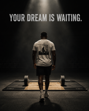 Powerlifter approaching a competition platform wearing the MooreMuscle Excuses Kill Dreams gym shirt.