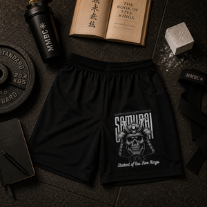 MooreMuscle Five Rings training shorts displayed with The Book of Five Rings and training accessories.