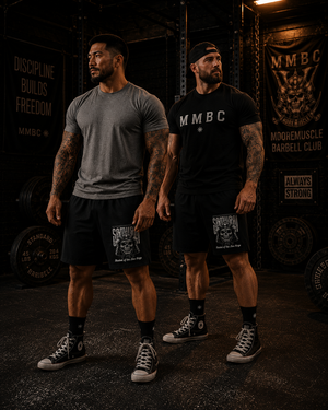 Two athletes wearing MooreMuscle Five Rings training shorts inside a powerlifting gym.