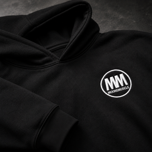 Black hoodie with MooreMuscle embroidered logo on a dark background