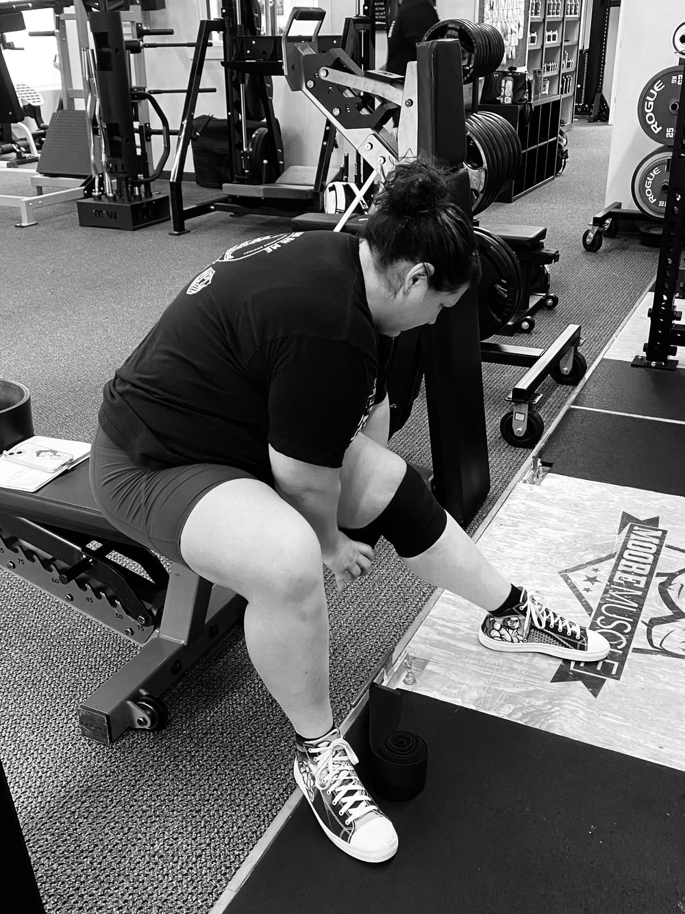 Black and white photo of a lifter preparing on a MooreMuscle platform