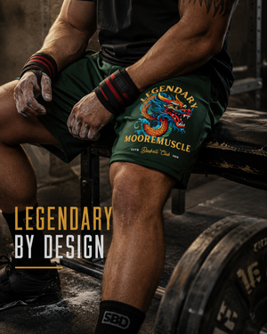 Close-up of green MooreMuscle Legendary shorts with colorful dragon graphic and performance fabric.