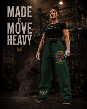Female powerlifter wearing green MooreMuscle Legendary sweatpants beside a squat rack with the text Made to Move Heavy.