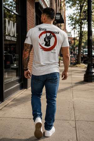 Male athlete walking through town wearing the white Never Surrender tee with the Doberman back graphic.