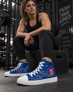 Female strength athlete seated between sets wearing blue MooreMuscle Push Your Limits high-top training shoes.