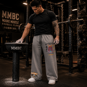 Athlete preparing for a squat session wearing gray Warrior Collection wide-leg sweatpants.
