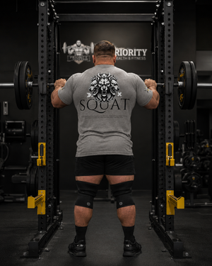 Male powerlifter wearing grey Squat Tee while preparing to squat