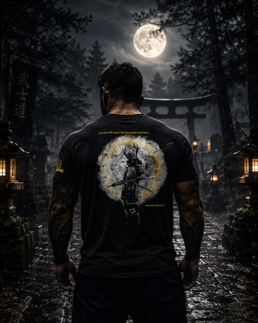 Warrior Collection tri-blend t-shirt featuring samurai graphic worn outdoors beneath a full moon in a Japanese-inspired forest setting