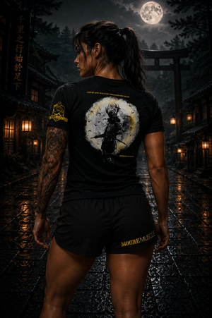 Person wearing a black t-shirt with a graphic design in a dark, atmospheric setting.