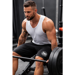 Male athlete wearing black MooreMuscle fleece shorts performing strength training in gym