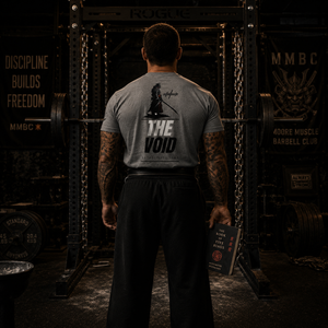 Rear view of The Void tri-blend tee inside a powerlifting gym.