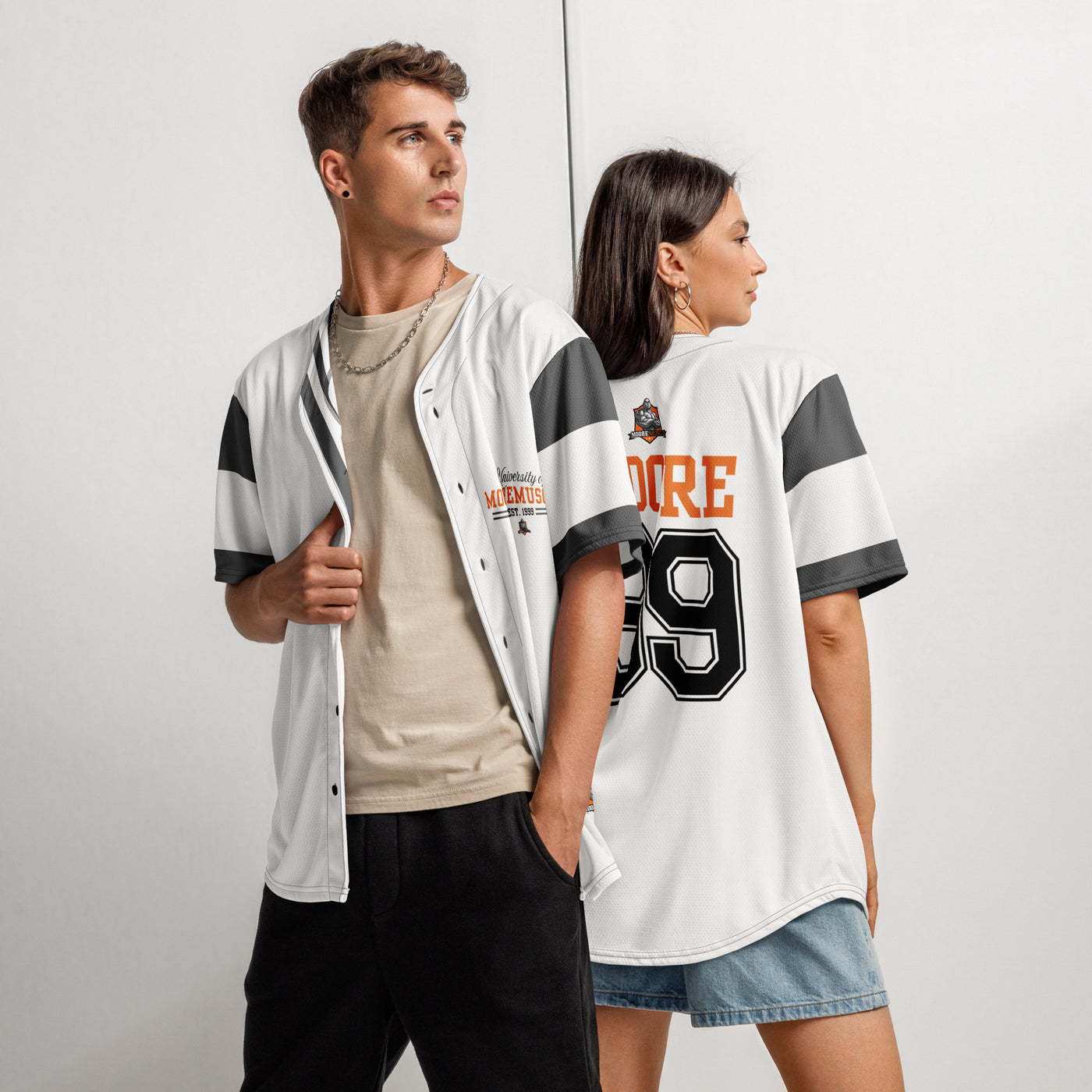 Male and female models wearing white MooreMuscle baseball jersey with dark sleeve stripes and orange lettering