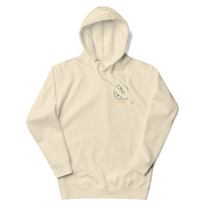 Front view of Into Valhalla hoodie in cream with minimal chest emblem and unisex fit