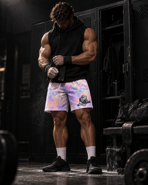 Male lifter wrapping his wrists in a dark gym locker room wearing MooreMuscle Afterglow tie-dye training shorts