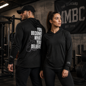 Male and female athletes wearing black MooreMuscle hooded long sleeve training tees in gym featuring “You Become What You Believe” back print
