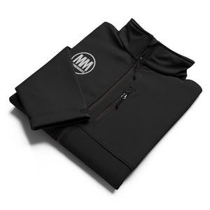 Folded black MooreMuscle Columbia soft shell jacket showing embroidered MM logo and clean construction details.