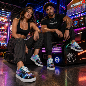 Asian female and male athletes wearing MooreMuscle glitch low top sneakers with white soles, seated in a neon-lit arcade environment with vibrant lighting highlighting the colorful shoe design