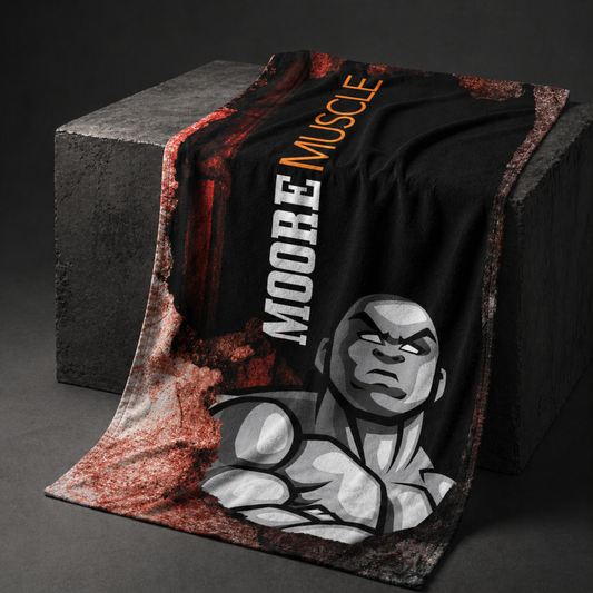 MooreMuscle grunge beach towel draped over a concrete block in a dark studio setting, highlighting bold black and red design, fabric texture, and natural folds