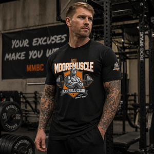 Male athlete wearing MooreMuscle MMBC Barbell Club t-shirt in gym setting