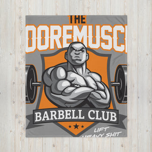 Close-up of MooreMuscle Barbell Club logo on throw blanket