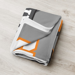 Folded MooreMuscle throw blanket showing soft fabric and design