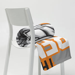 MooreMuscle blanket folded over chair with visible logo detail