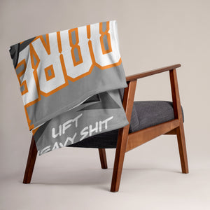 MooreMuscle Barbell Club blanket draped over chair with bold lettering
