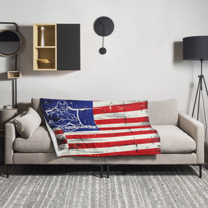 MooreMuscle American flag throw blanket displayed on a couch in a living room setting