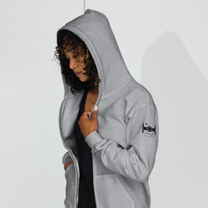 Model wearing Never Surrender zip hoodie in heather gray showing relaxed fit and everyday wear